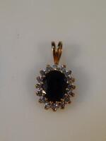 A 9ct gold diamond and sapphire set pendant.