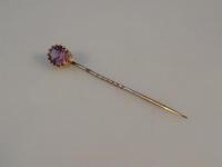 An amethyst set stick pin