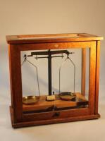 An oak cased chemistry scale balance