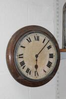 An oak cased circular wall clock