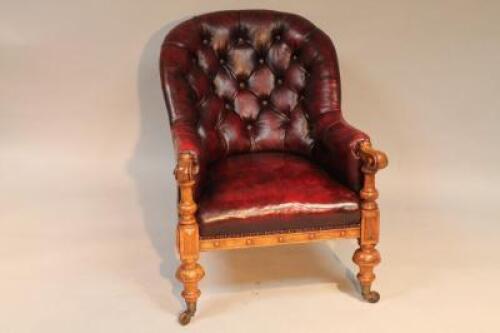 A late Victorian oak button back easy chair.