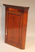 A late 18thC oak and mahogany corner cupboard