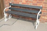 A 20thC cast metal and wood garden bench.