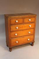 A Victorian scumbled pine chest of two short and three long drawers