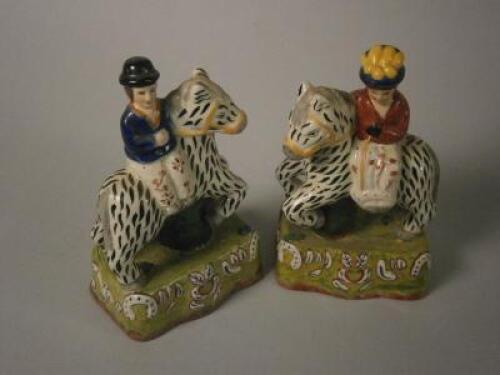 A pair of reproduction Staffordshire figures of lady and gentleman.