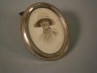 An oval silver mounted photograph frame