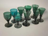 A group of nine green tinted Victorian wine glasses