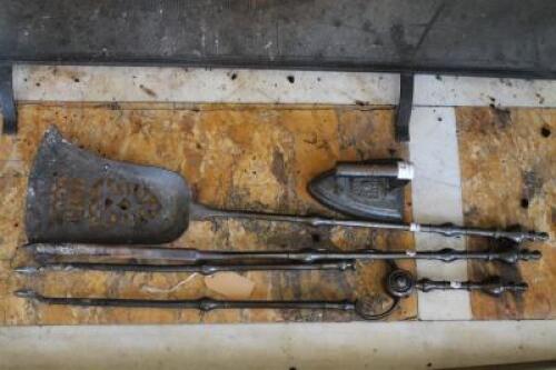 A set of three polished steel fire irons and a flat iron. (4)