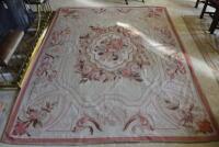 An Aubusson pink bordered carpet