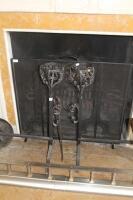 A pair of wrought iron andirons with basket tops