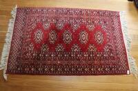 A Bokhara type red ground rug