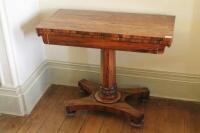 A Victorian rosewood card table with rectangular folding baize top