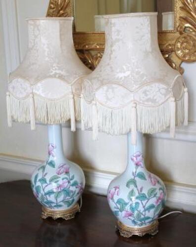 A pair of Chinese famille rose bottle vase lamps with tasselled Damask shades