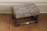 A small oak joint stool with floral tapestry upholstery