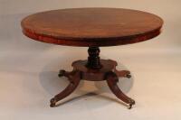 A mid 19thC circular centre table with rosewood and satinwood stringing on turned base with scrolled