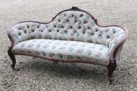 A Victorian walnut serpentine sofa on cabriole legs