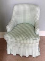 An upholstered tub chair in green Gingham material