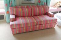 A candy stripe double bed settee.