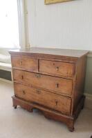 An early 18thC elm chest of two short and two long drawers