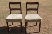 A pair of Regency dining chairs.