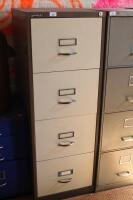 A brown/cream four drawer filing cabinet.