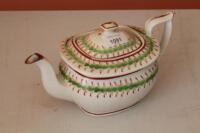 A New Hall teapot with green and red borders.