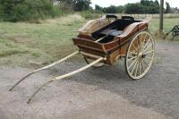 A painted wooden two wheel trap.