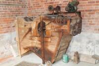 A vintage wooden framed threshing machine
