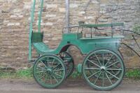 A green Phaeton horse carriage.