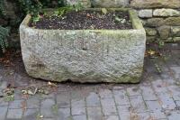 A hand hewn stone trough