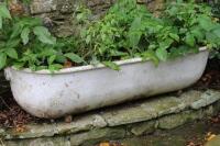 A cast metal pig trough