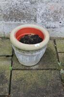 A small concrete jardiniere.