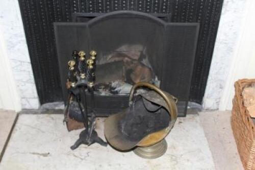 A spark guard with fire implements and a brass coal scuttle