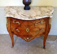 An 18thC French ormolu mounted tulip wood serpentine commode