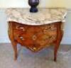 An 18thC French ormolu mounted tulip wood serpentine commode