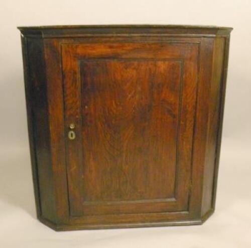 An early 19thC elm corner cabinet