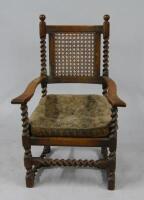 An early 20thC oak bergere armchair