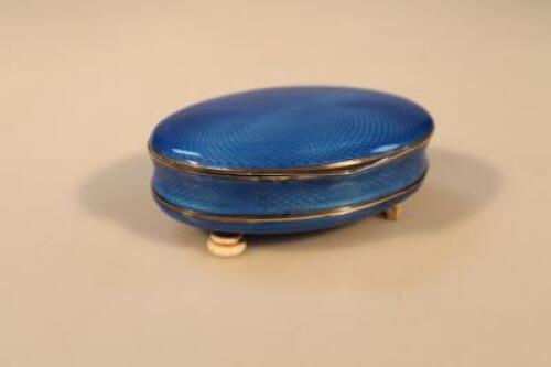 A Continental white metal and gilt oval enamelled pill box