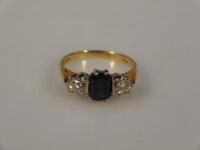 An 18ct diamond and sapphire three stone ring