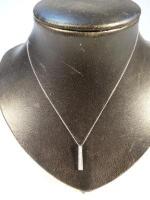 A 9ct white gold pendant and chain