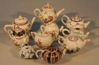 A small collection of Franklin Mint Victoria and Albert Museum miniature tea pots.