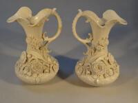 A pair of Belleek Aberdeen flowered jugs