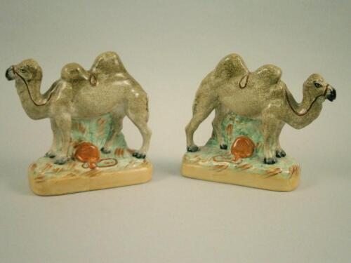 A pair of 19thC Staffordshire flatback camel figures