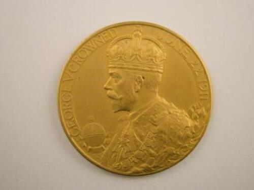 A gold George V medallion