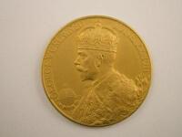 A gold George V medallion