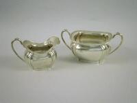 A silver two handled sugar bowl