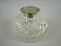 A circular cut glass inkwell