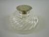 A circular cut glass inkwell