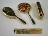 A silver and tortoise-shell mounted part dressing table set