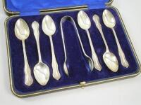 A set of six silver teaspoons and matching sugar tongs